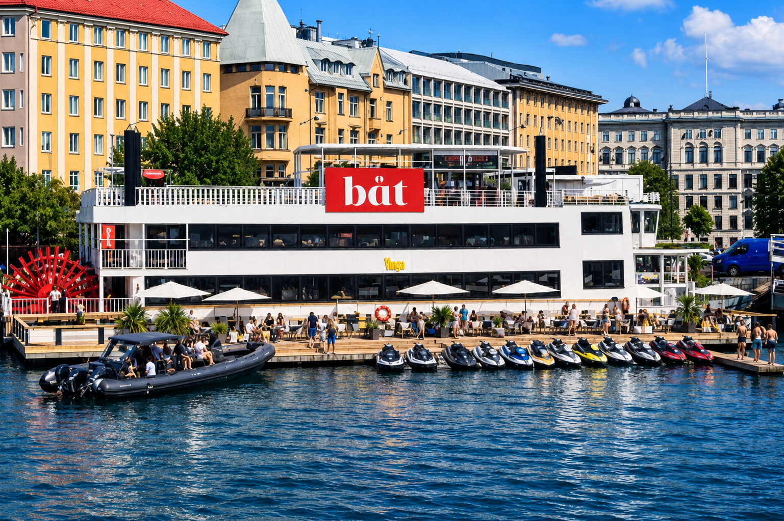 Restaurant Boat BÅT seen from the sea with jet skis docked